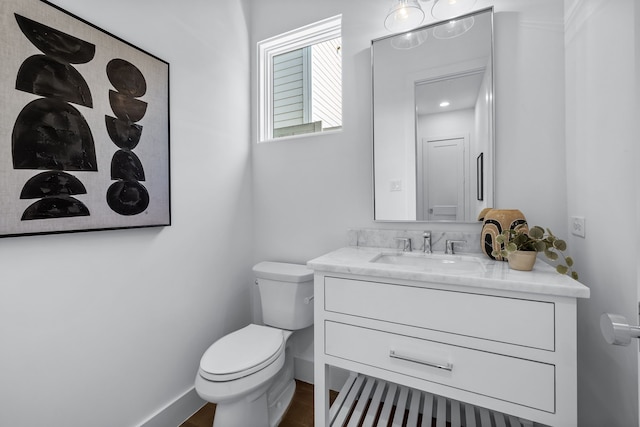 bathroom featuring vanity and toilet