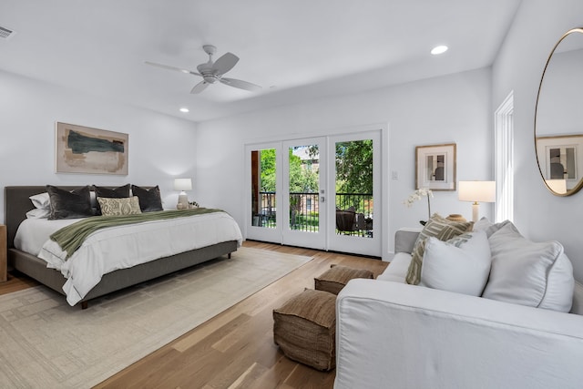 bedroom featuring ceiling fan, access to exterior, and light hardwood / wood-style flooring