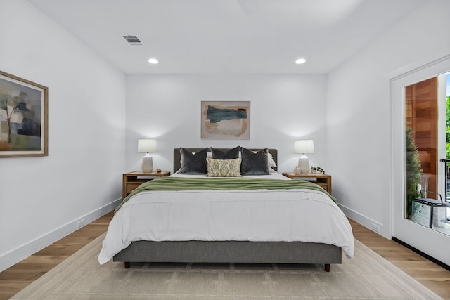 bedroom featuring light hardwood / wood-style floors and access to outside