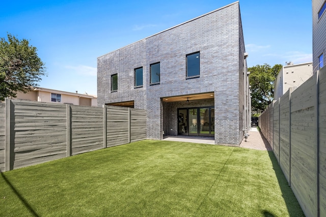 rear view of house featuring a lawn