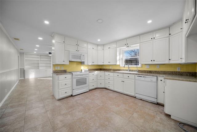 kitchen with white cabinetry, sink, built in features, and white appliances