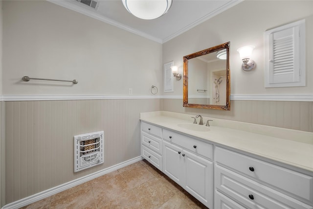 bathroom with crown molding, vanity, tile patterned flooring, and heating unit