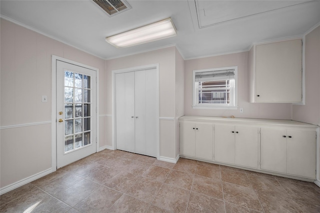 kitchen with ornamental molding and white cabinets