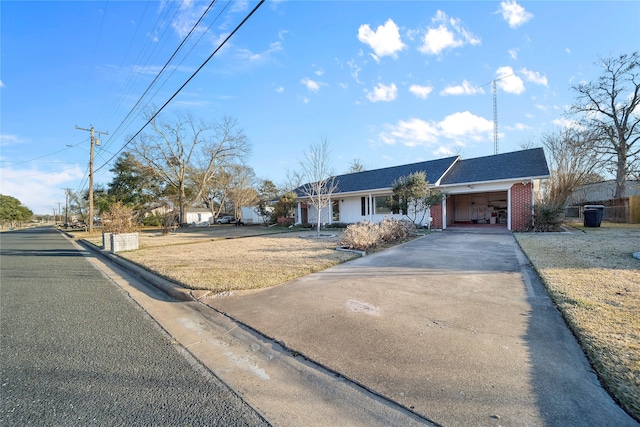 ranch-style home with a garage and a front lawn