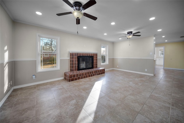 unfurnished living room featuring light tile patterned flooring, ceiling fan, ornamental molding, and a tiled fireplace