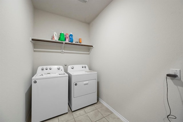 washroom featuring washing machine and dryer and light tile patterned floors