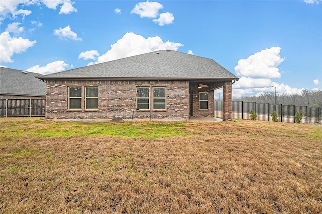 rear view of property with a yard and a patio area