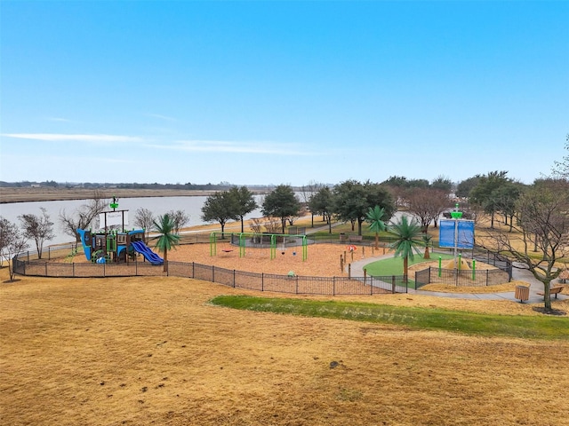 view of jungle gym featuring a water view and a yard