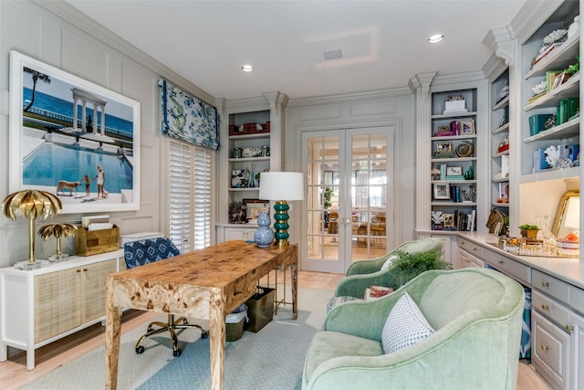 office with built in shelves, a healthy amount of sunlight, crown molding, and french doors