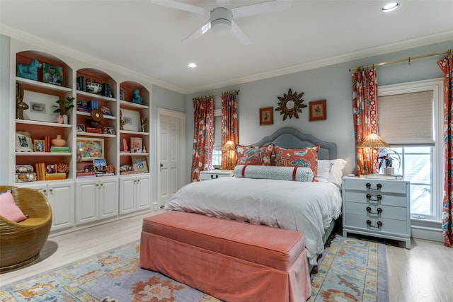 bedroom with crown molding, light hardwood / wood-style floors, and ceiling fan