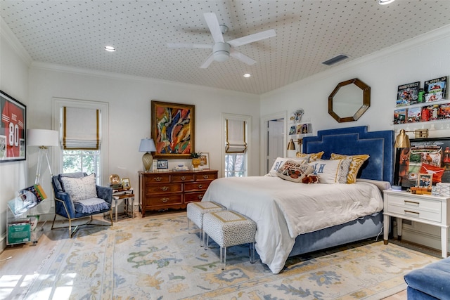 bedroom featuring crown molding, ceiling fan, and hardwood / wood-style flooring