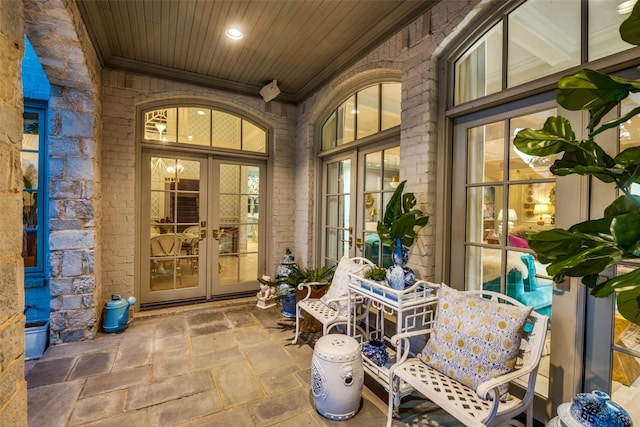 property entrance featuring a patio area and french doors