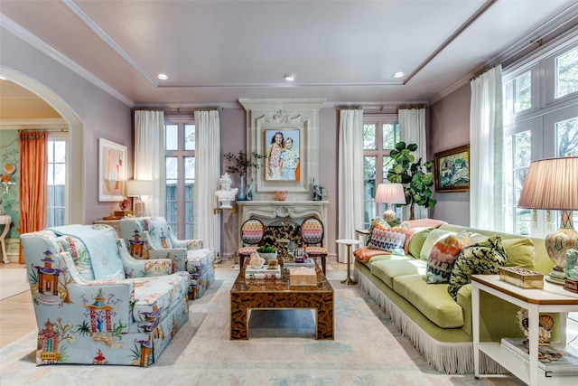 living area with crown molding and plenty of natural light