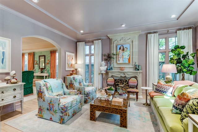 living area featuring crown molding and light wood-type flooring