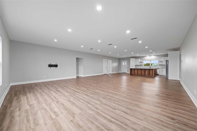 unfurnished living room featuring light wood-type flooring