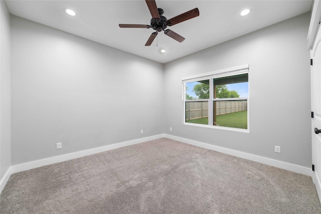 empty room featuring ceiling fan and carpet