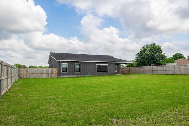 back of property featuring a lawn