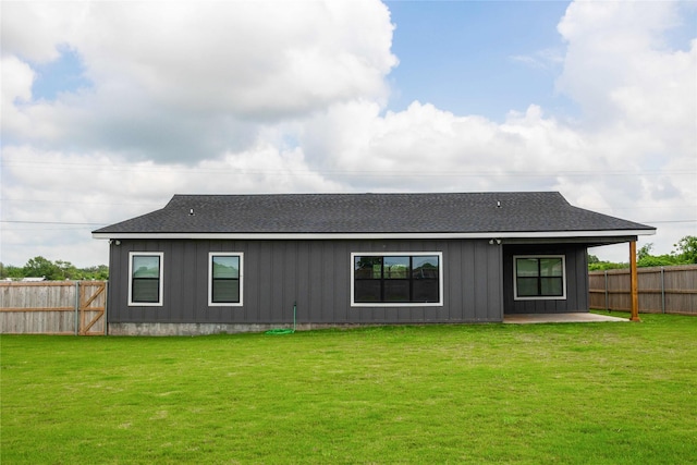 back of house with a patio and a yard