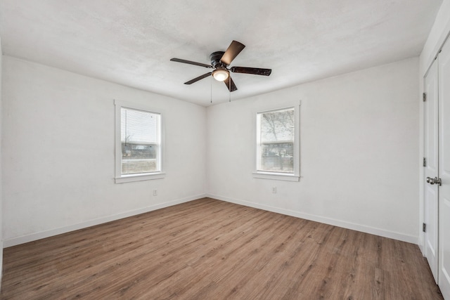 empty room featuring light hardwood / wood-style flooring, plenty of natural light, and ceiling fan