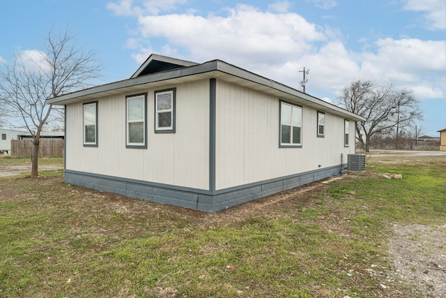 view of home's exterior featuring a yard and central AC unit