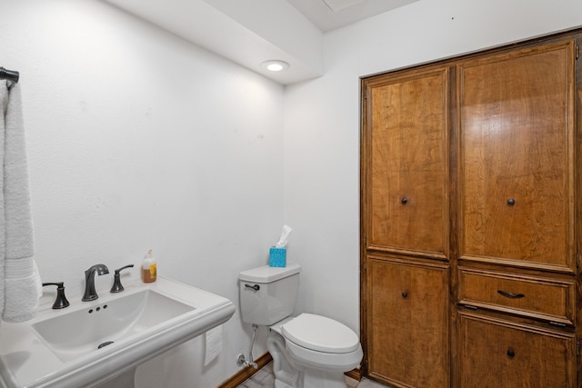 bathroom featuring sink and toilet