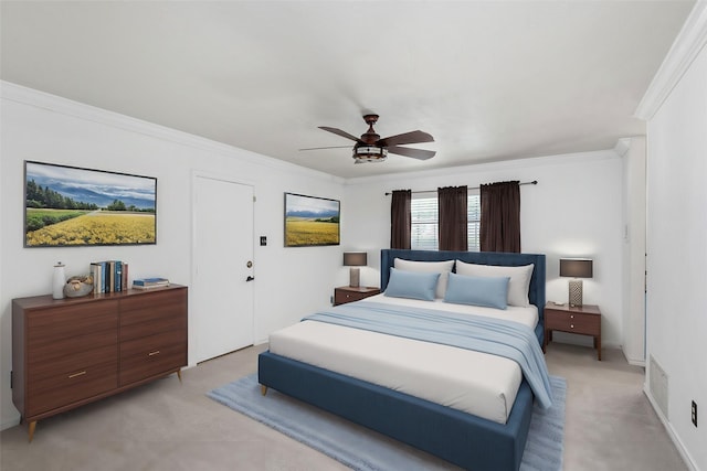 bedroom featuring light colored carpet, ornamental molding, and ceiling fan