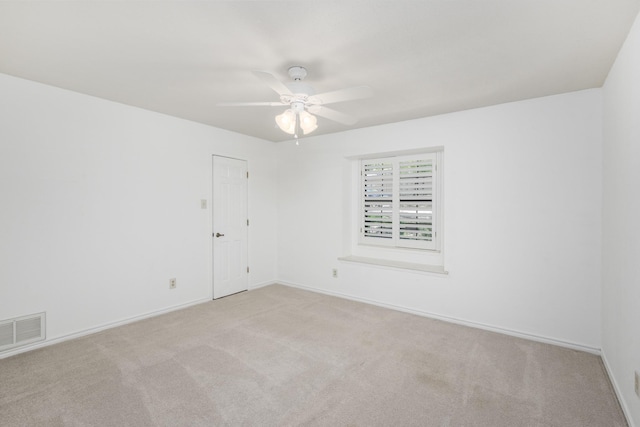 unfurnished room featuring light colored carpet and ceiling fan