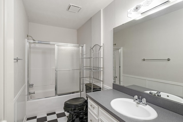 bathroom featuring vanity and combined bath / shower with glass door