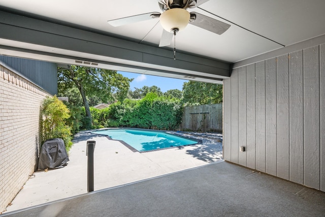 view of swimming pool with ceiling fan and a patio