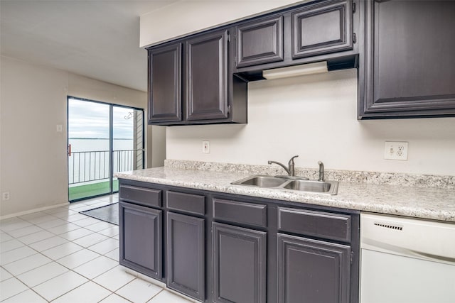 kitchen with white dishwasher, a sink, light countertops, light tile patterned floors, and baseboards