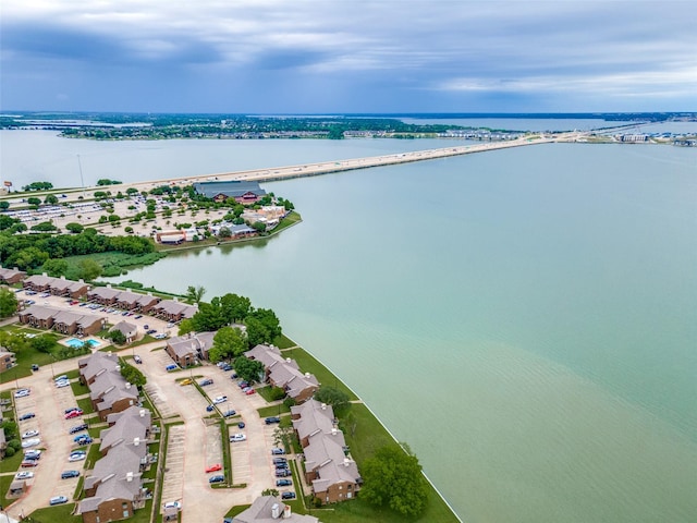 aerial view of residential area with a large body of water and a notable bridge