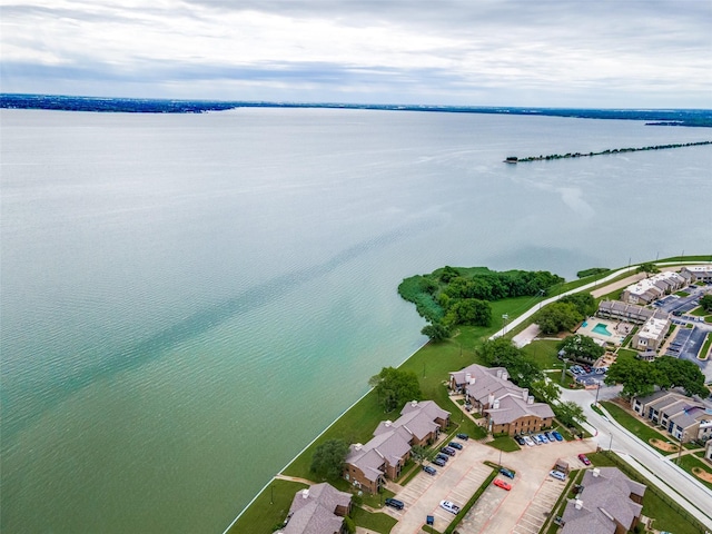aerial overview of property's location with a nearby body of water and nearby suburban area