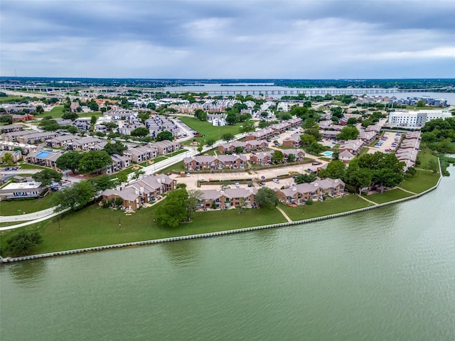 aerial view of residential area featuring a large body of water