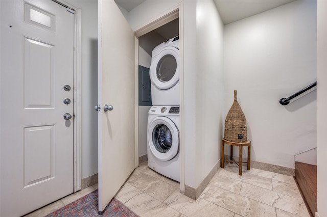 clothes washing area featuring stacked washer and dryer