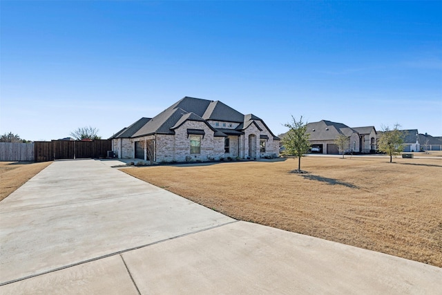 french country style house featuring a front yard