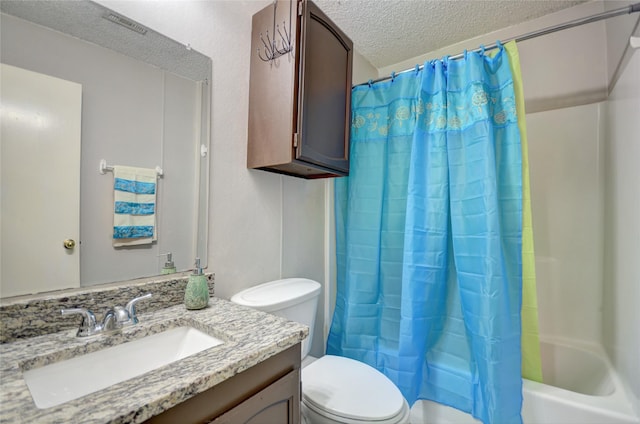 full bathroom featuring vanity, shower / tub combo with curtain, a textured ceiling, and toilet