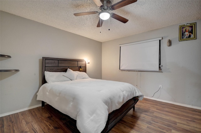 bedroom featuring ceiling fan, dark hardwood / wood-style floors, and a textured ceiling