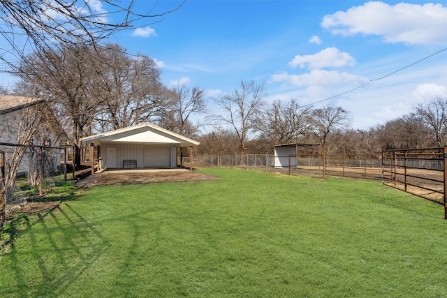 view of yard featuring a garage and an outdoor structure