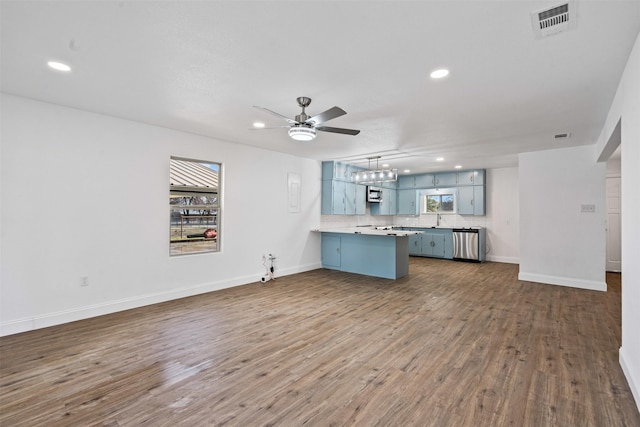 unfurnished living room with dark wood-type flooring and ceiling fan