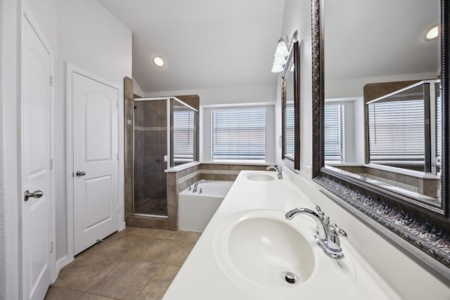 bathroom with vanity, vaulted ceiling, tile patterned floors, and separate shower and tub