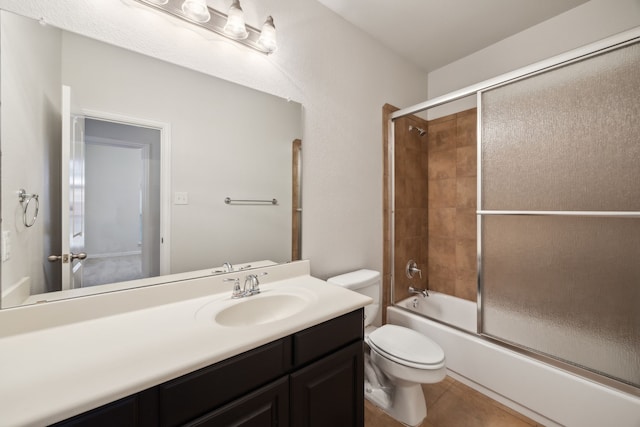 full bathroom with vanity, tile patterned floors, toilet, and combined bath / shower with glass door