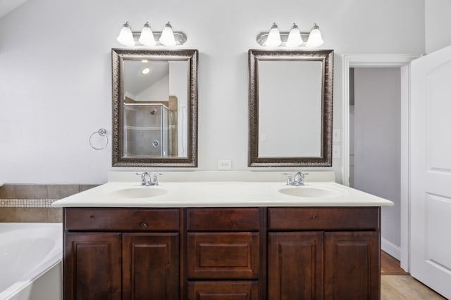 bathroom with vanity and independent shower and bath