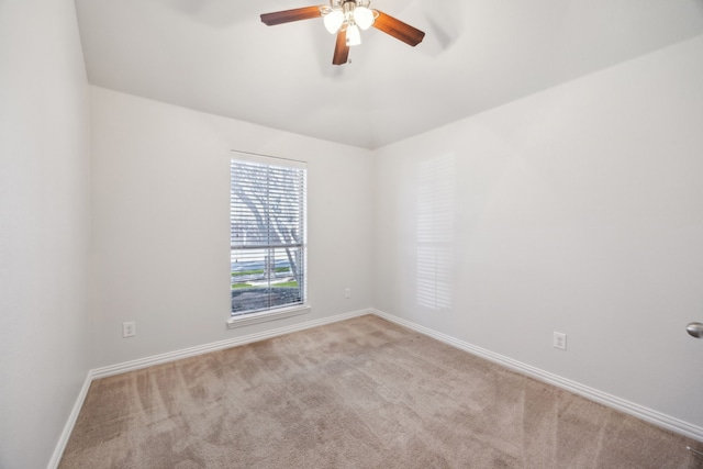 carpeted empty room featuring ceiling fan