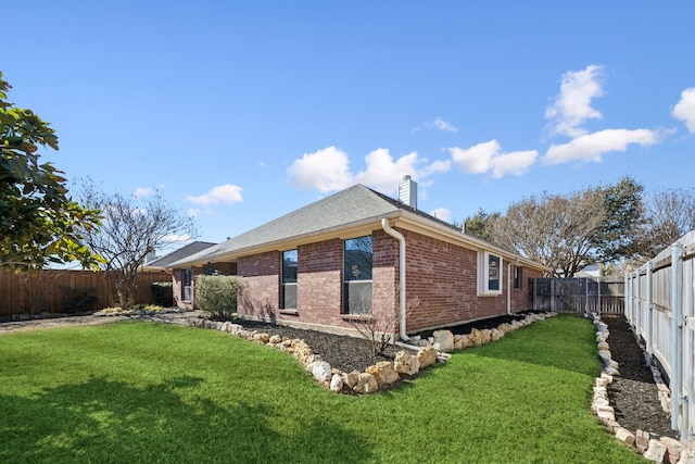 view of side of home with a lawn