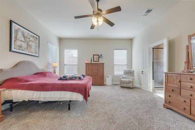 bedroom with light carpet, ceiling fan, and ensuite bathroom