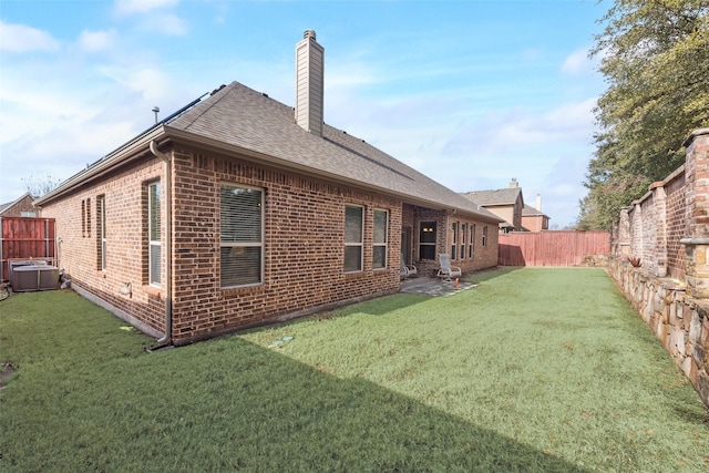 rear view of property featuring a yard