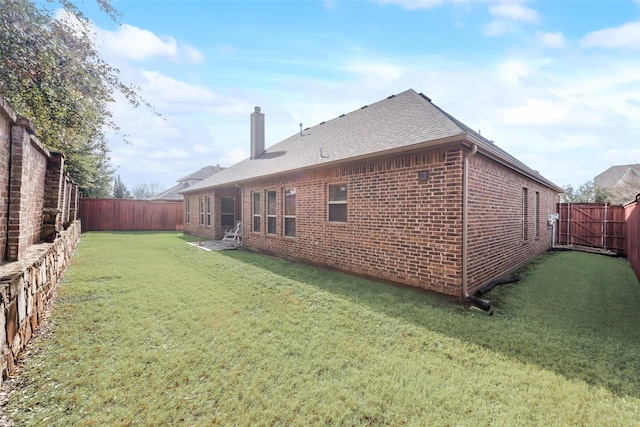 back of property featuring a yard