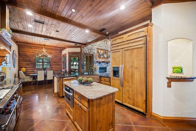 kitchen with decorative light fixtures, wooden ceiling, premium appliances, a kitchen island, and beamed ceiling