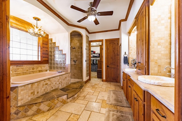 bathroom featuring ornamental molding, separate shower and tub, ceiling fan with notable chandelier, and vanity