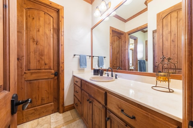 bathroom featuring ornamental molding and vanity